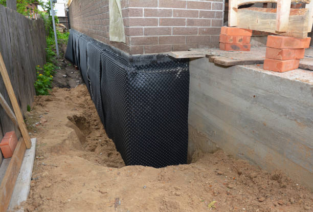 SJ Waterproofing Pros technician performing targeted Interior Drainage System assessment in Baxter, TN
